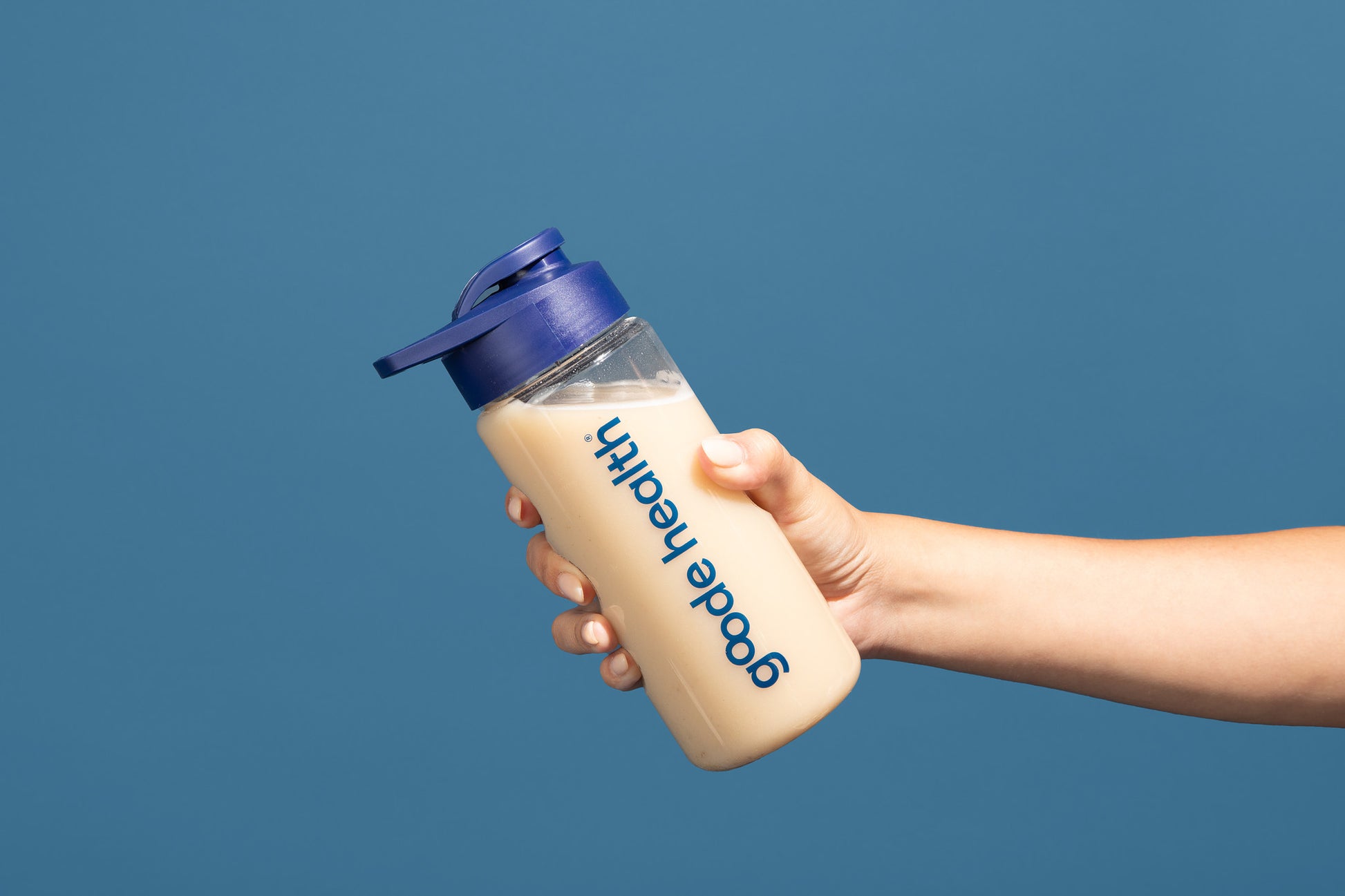 Image of woman holding full Goode health shaker 