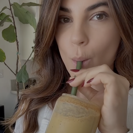 Woman drinking Goode health shake using a straw
